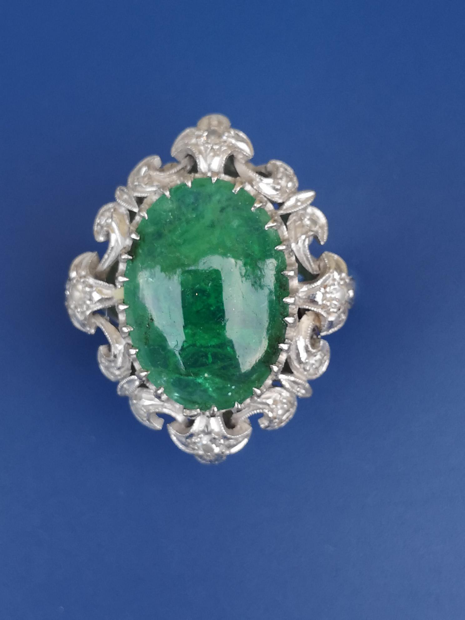 A cabochon emerald & diamond set 18ct white gold ring, the elaborately pierced openwork claw