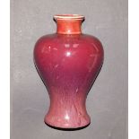 A Chinese Sang de Boeuf porcelain vase of Meiping shape, with pale grey glaze to neck rim and