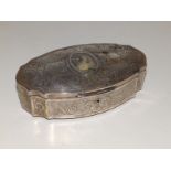 A late 19th/early 20thC French oval silver dressing table box, the hinged lid inset with a glazed