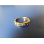 A diamond set 18ct gold half eternity ring - total diamond weight 0.50 carat. Finger size M.