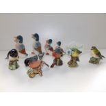 A Beswick bullfinch, four other Beswick birds, a John Beswick Studio (Royal Doulton) retailer's