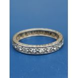 A diamond set 18ct white gold eternity ring, having foliate engraved decoration to sides of