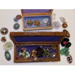 Two wooden boxes containing a collection of costume brooches.