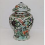 A Chinese famille verte porcelain covered vase, the sides decorated with bold flowering plants and