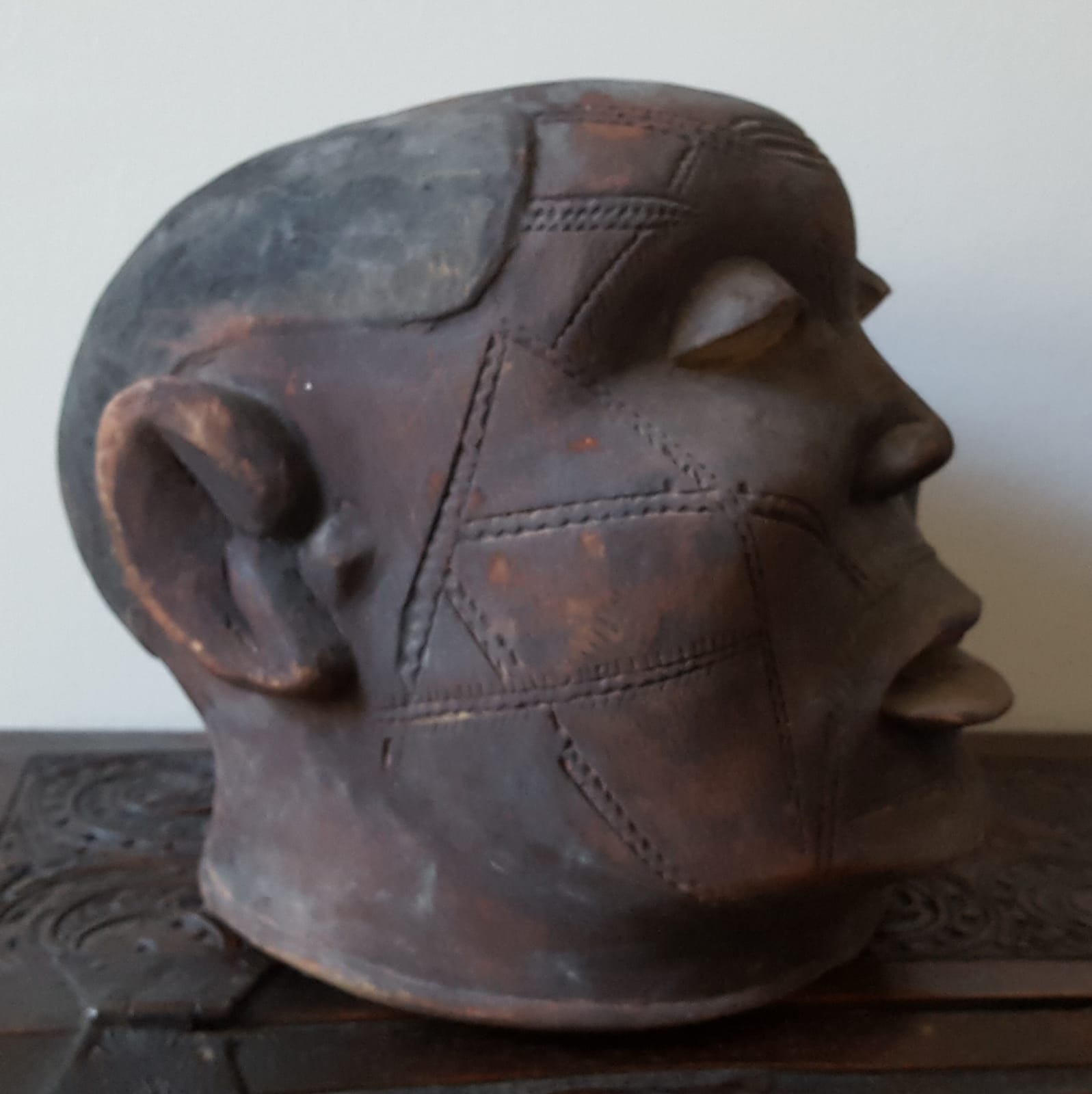 An African Makonde helmet mask, the face with extensive scarification. - Image 2 of 4