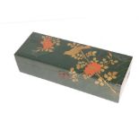 A Japanese dark green lacquered box, the hinged cover decorated with a bird perched on a flowering