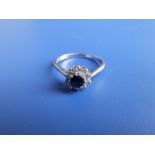 A small modern sapphire & diamond circular cluster ring set in 18ct white gold. Finger size R.