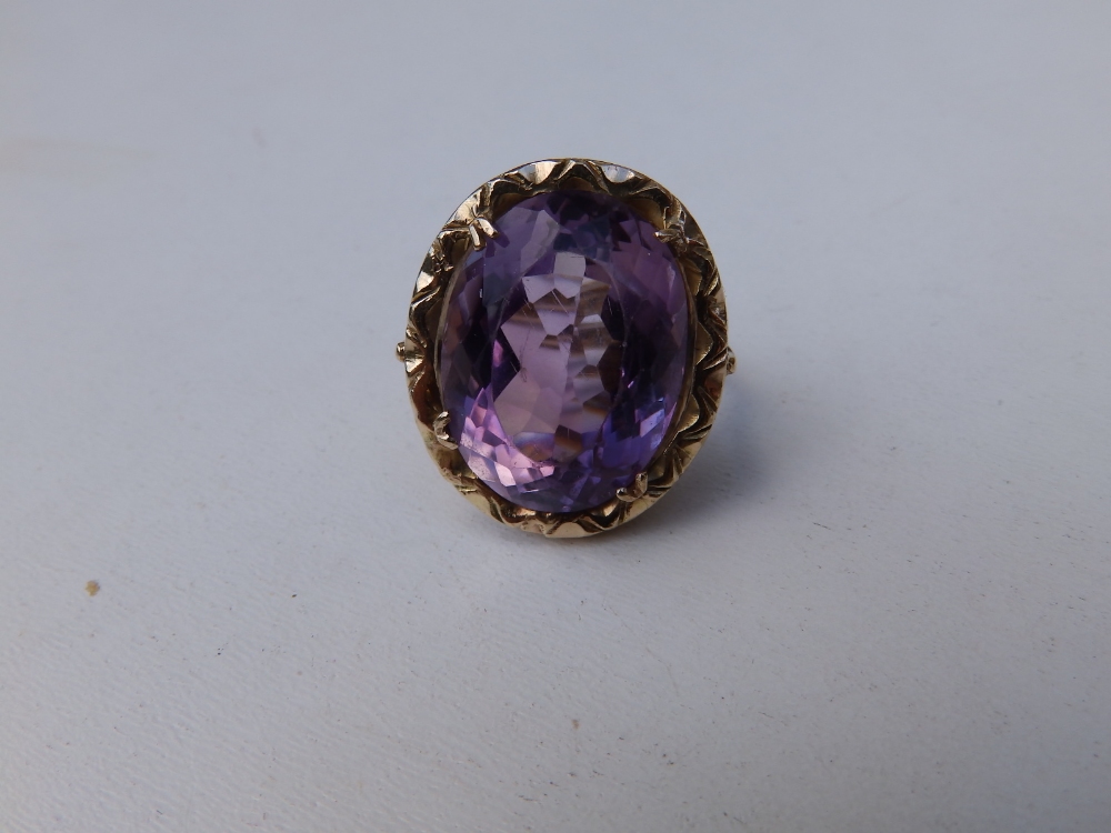 A large oval amethyst single stone ring in 9ct gold. Finger size K/L.