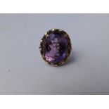 A large oval amethyst single stone ring in 9ct gold. Finger size K/L.