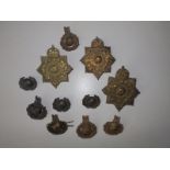 Three Royal Marine helmet plates, four Royal Marine cap badges, an officer's cap badge and three