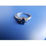 A small modern three stone sapphire & diamond ring in K18 white metal. Finger size I.