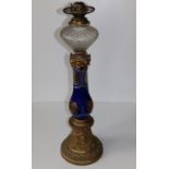 A tall 19thC blue glass oil lamp with engraved decoration to the glass column and (rubbed)