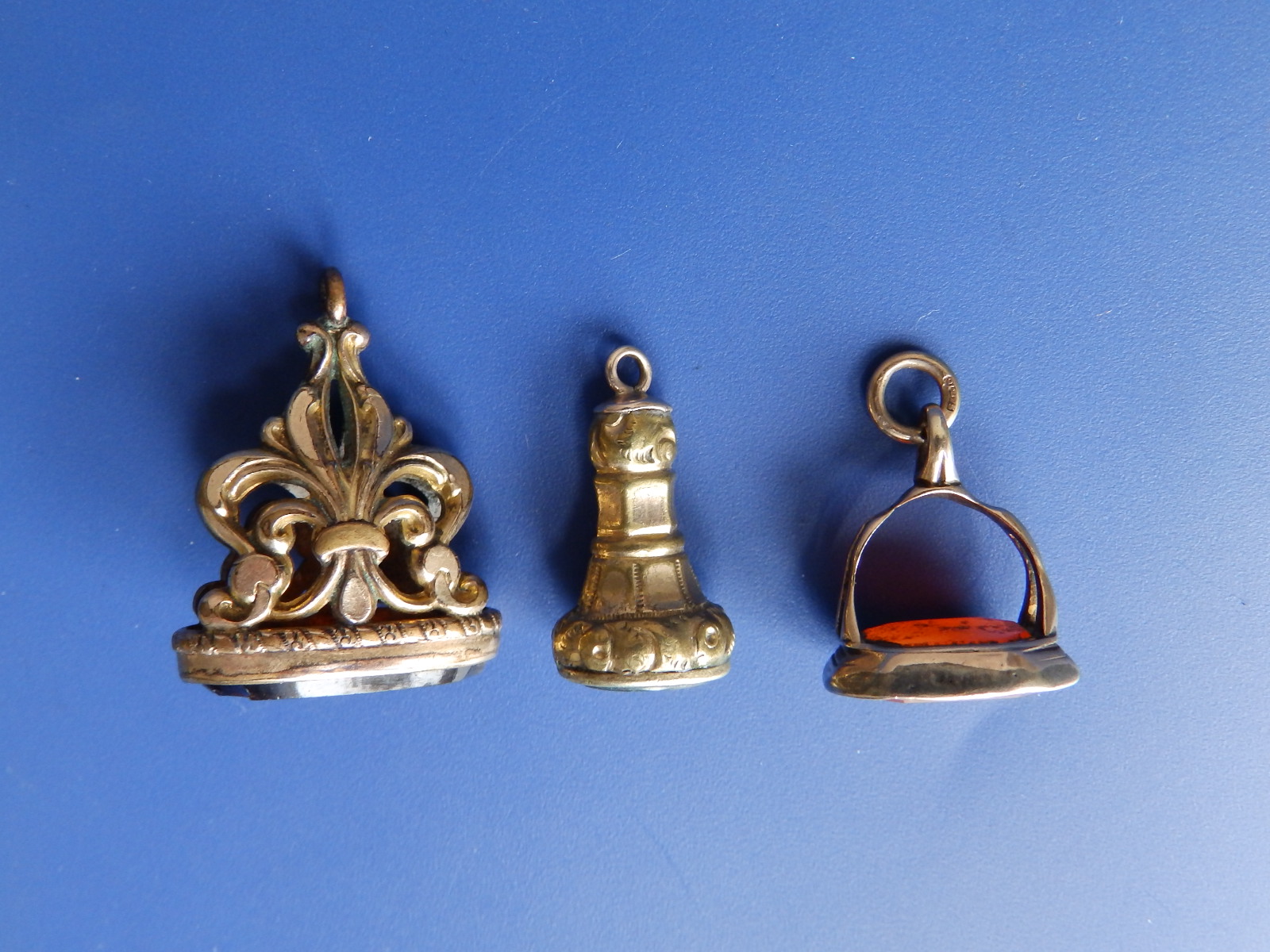 Three antique seal fob pendants, the largest 1.1" high having chips to the obsidian stone.