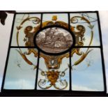 A stained glass leaded light panel, decorated with a courting cuple in Renaissance Revival taste,