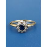 A small oval sapphire & diamond cluster ring on 18ct gold shank. Finger size P.