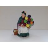 A Royal Doulton figurine 'The Old Balloon Seller' HN1315, 7.25" high and 'Lucy' HN4459, 8" high (2)