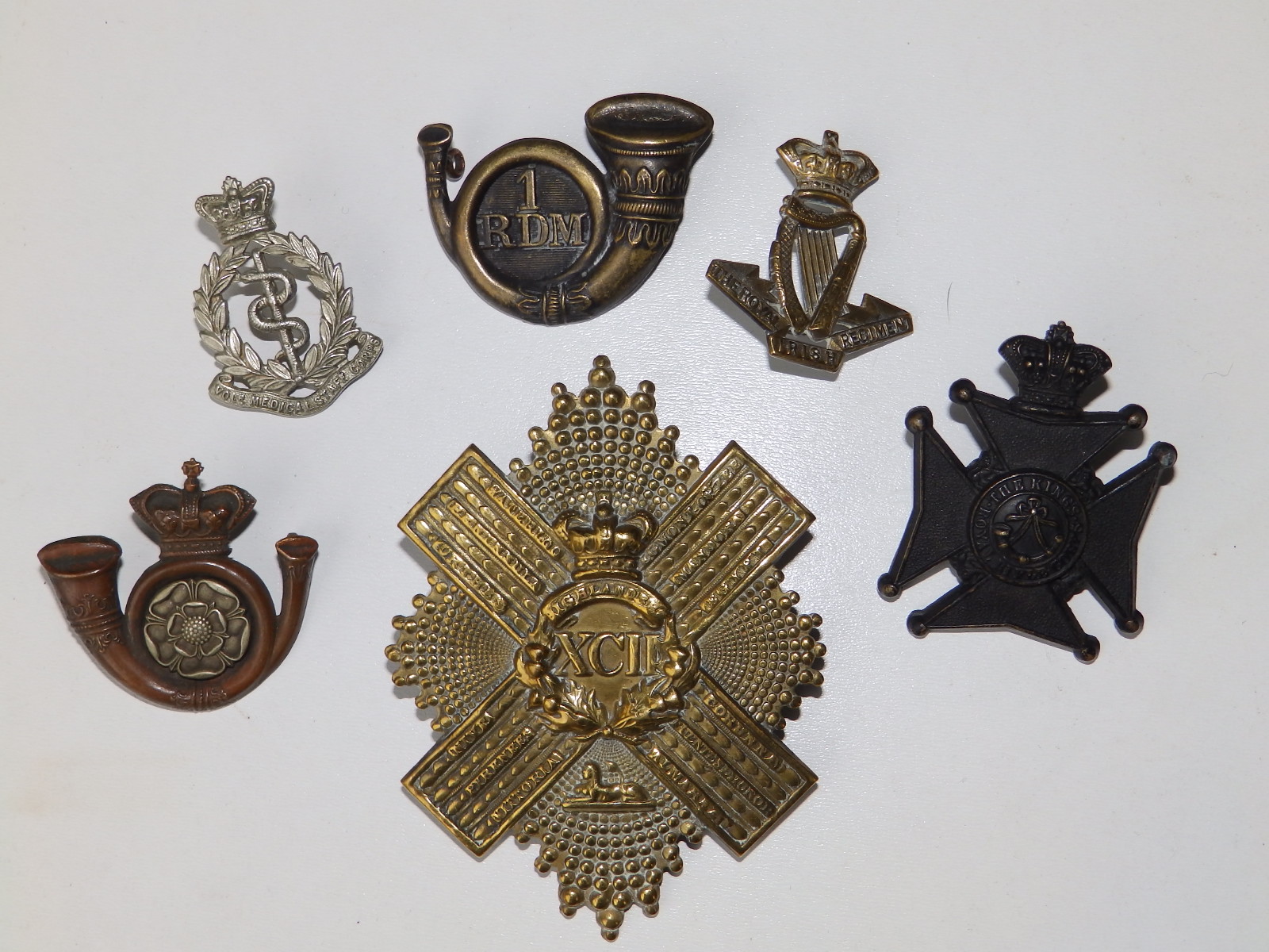 Six Victorian military badges.