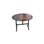 An antique oak oval occasional tilt-top table on folding stand.