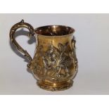 A Victorian silver gilt mug , having repousse decoration of roses and thistle and with an applied