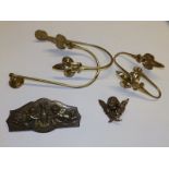 A pair of brass curtain ties, another pair and two small brass cherub plaques. (6)