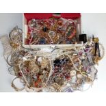 A modern white jewellery box containing a large quantity of costume jewellery.
