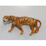 A Beswick tigress, 8.5" across and a Beswick sow with piglet on her back, 6.5" across. (2)