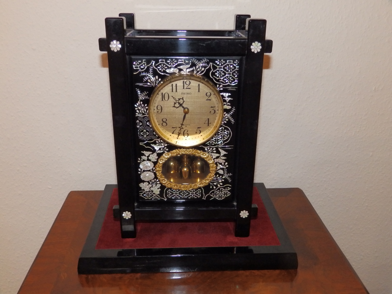 A modern Japanese Seiko battery operated mantel clock in ebonsied Aesthetic taste, 14" high.