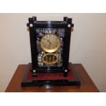 A modern Japanese Seiko battery operated mantel clock in ebonsied Aesthetic taste, 14" high.