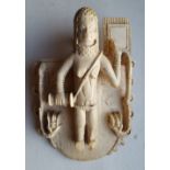 An 18thC African Benin carved ivory waist pendant, depicting a female figure standing against a