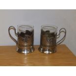 A pair of Russian glass beakers in EP holders.