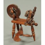 A small 19th century spinning wheel, turned wood. Height 44 cm.