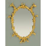 A Georgian carved giltwood framed mirror, in the rococo style. Height 94 cm, width 63 cm.