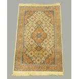 A Persian design woollen rug, with centre rectangular panel, multiple line border and fringed ends,