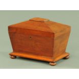 A William IV mahogany tea caddy, of sarcophagus form, raised on short bun feet. Width 31 cm.