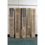 Eight stripped pine louvre doors, all +/- 2 m 11 cm, various widths between 28 cm and 39 cm.