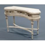 A shabby chic kidney shaped hall table, with cream painted body,