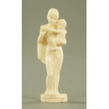 A carved ivory figure of an Indian mother with child, late 19th/early 20th century, carved standing.