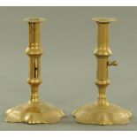 A pair of 18th century brass candlesticks, with petal shaped bases, push rod ejectors, height 18 cm.