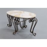 A wrought iron and marble topped oval coffee table,
