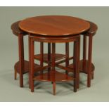 An Edwardian mahogany circular nest of tables, with one large table and four quadrant tables.
