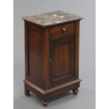 A marble topped bedside cabinet, with drawer and cupboard below, raised on turned legs.