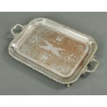 A silver plated and copper rectangular drinks tray, foliate engraved. Length 57 cm.