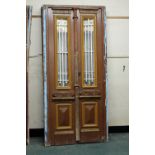 A pair of North African doors, painted pine with wrought iron decoration to the top panels.