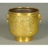 A brass armorial jardiniere, with carrying handle to either side. Diameter 28 cm.