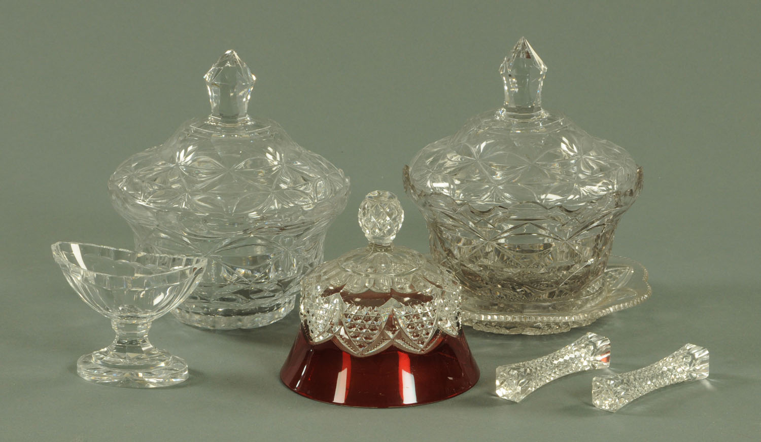 A pair of cut glass bowls and covers, one with stand, height 20 cm, a pair of cut glass knife rests,