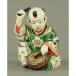 A Japanese Kutani Karako drummer boy, Taisho period, modelled seated,