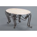 A marble topped and wrought iron coffee table, with oval top and four downswept legs.