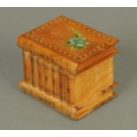 An olive wood Sorrento puzzle box, in the form of a stack of books. Width 11.5 cm.