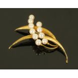 A 14 ct gold and pearl set brooch, stamped "585", presented in an earlier Mappin & Webb box.