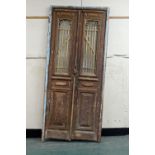 A pair of North African exterior doors housed within a door frame,